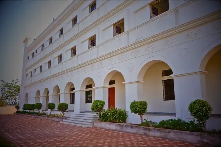 A white building featuring elegant arches and arched windows, showcasing a classic architectural design.