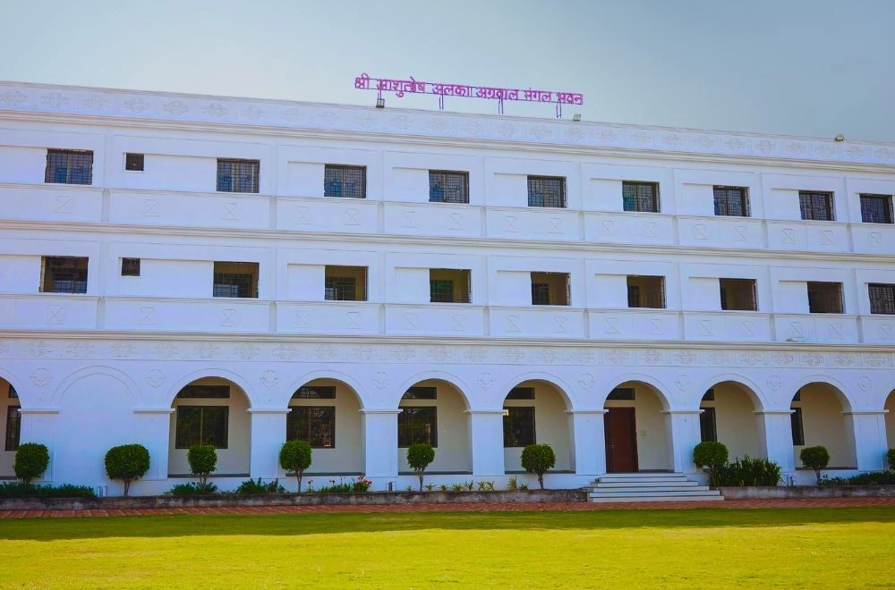A white building featuring elegant arches and a prominent clock on its facade, showcasing classic architectural design.
