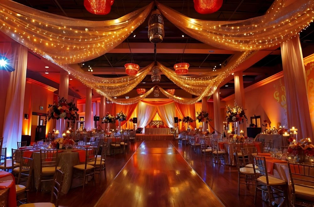 A long table surrounded by white chairs, elegantly arranged for a gathering or dining experience.