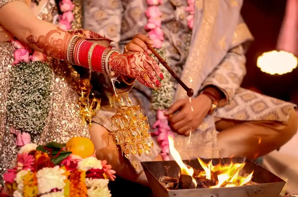 A vibrant Indian wedding ceremony, showcasing traditional attire, decorations, and joyful celebrations among guests.