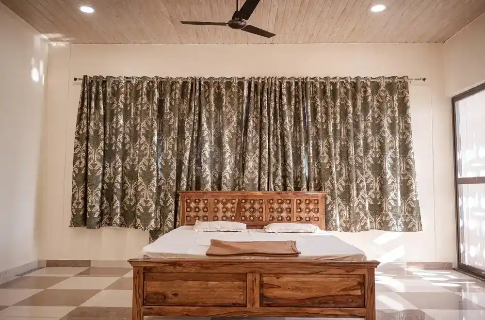 A spacious hall featuring white walls and elegant wooden ceilings, creating a bright and inviting atmosphere.