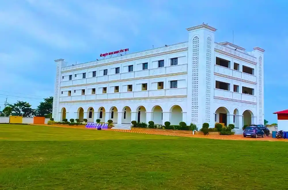 A white building with red roofs stands prominently on a barren dirt field, showcasing a stark contrast in colors.