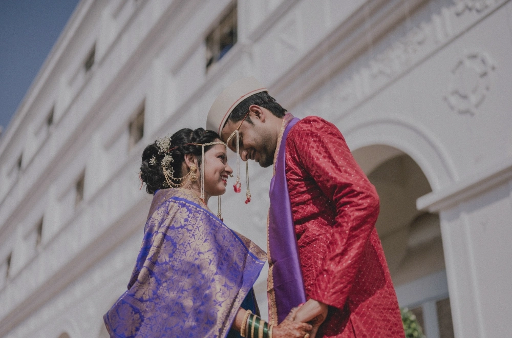 A vibrant Indian wedding ceremony in Mumbai, showcasing traditional attire, decorations, and joyful celebrations among guests.